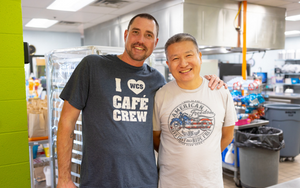  Two male cafeteria workers in the school kitchen